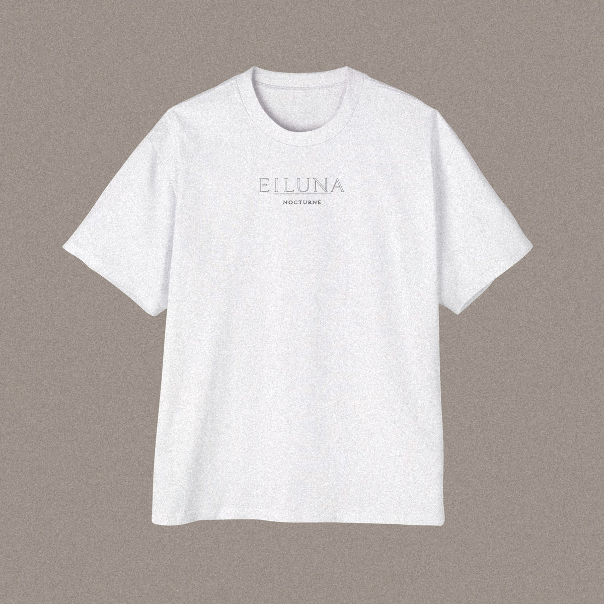 Front of an oversized white t-shirt laid flat, with the EILUNA wordmark and NOCTURNE printed small and centred on the chest.
